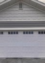 Vertical Whispy white clouds Traditional garage exterior with white and gray tone color palet