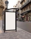 A vertical white blank billboard mockup at a bus stop on a city street. Bus stop billboard mockup Royalty Free Stock Photo