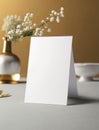 White paper mockup with flowers in restaurant. Empty card for wedding table number or dinner menu template. Generative AI Royalty Free Stock Photo