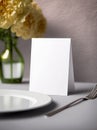 White paper mockup with yellow flowers in restaurant. Empty card for wedding table number or dinner menu template. Generative AI Royalty Free Stock Photo