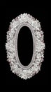 A vertical white lace oval doily frame, top view on a black background. The lace is embroidered with symmetrical openwork and an Royalty Free Stock Photo