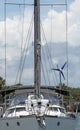 Vertical of a white sailboat moored at a harbor Royalty Free Stock Photo