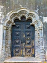 Vertical of wood carved door with stone work, lateral entrance of Elvas main church Royalty Free Stock Photo
