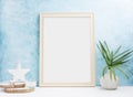 Vertical wooden Photo frame mock up with plants in vase, ceramic decor on shelf. Scandinavian style Royalty Free Stock Photo