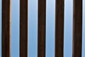 Vertical wooden slats with blue sky as background Royalty Free Stock Photo