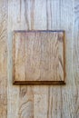 Vertical wooden surface with a square protrusion in the middle