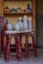 Vertical of a workshop with ceramic jars on an antique stool Royalty Free Stock Photo
