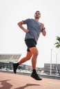 Vertical. Young and strong male running for health, wellness or training for a marathon, competition or race, showing