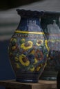 Vertical selective focus closeup of artistic ceramic pots on the table