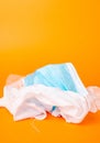 Verticl shot of disposable facemask and gloves isolated on orange background Royalty Free Stock Photo