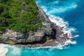 Vertiginous, swirling foamy water waves at the ocean photographed from above cliff. Royalty Free Stock Photo