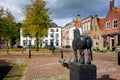A typical old Dutch town with a market square and a statue of a farmer`s horse.