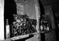 Very ancient bottles of wine lies in retro dark cellar