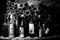 Very ancient bottles of wine lies in retro dark cellar