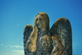 Very ancient stone statue of beautiful angel in moss