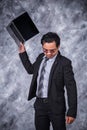 Angry business man is throwing away his laptop Royalty Free Stock Photo