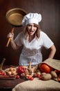 Very angry chef with big frying pan in hand. Royalty Free Stock Photo