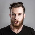 Very angry young man isolated on gray background Royalty Free Stock Photo