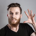 Very angry young man isolated on gray background Royalty Free Stock Photo