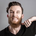 Very angry young man isolated on gray background Royalty Free Stock Photo