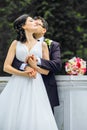Very beautiful bride with groom hugging and dancing in green park, real wedding couple together forever happy smiling Royalty Free Stock Photo