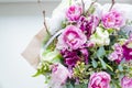 Very beautiful colorful blossoming flower bouquet of fresh Quicksand roses, carnations, ranunculus, peony, branches with Royalty Free Stock Photo