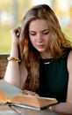 Blonde girl with long,light hair read interesting book outdoors