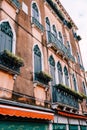 Close-ups of building facades in Venice, Italy. Very beautiful old Venetian windows on the facade of the building pink Royalty Free Stock Photo
