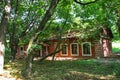 Very beautiful red brick house surrounded by trees and grass