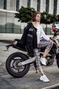 Very beautiful but serious girl on a stylish sport motorcycle Royalty Free Stock Photo