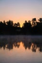 Very beautiful sunrise in summer over a foggy lake. Early morning in summer in nature. Defocused Royalty Free Stock Photo