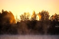 Very beautiful sunrise in summer over a foggy lake. Early morning in summer in nature. Defocused Royalty Free Stock Photo