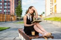 Very beautiful young girl reads a book on a bench Royalty Free Stock Photo