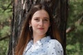 Very beautiful young woman in coniferous forest in summer in hot sunny weather Royalty Free Stock Photo