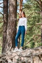 Very beautiful young woman in coniferous forest in summer in hot sunny weather Royalty Free Stock Photo