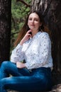 Very beautiful young woman in coniferous forest in summer in hot sunny weather Royalty Free Stock Photo