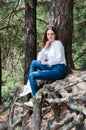 Very beautiful young woman in coniferous forest in summer in hot sunny weather Royalty Free Stock Photo