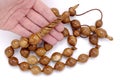 Very big wood prayer beads at hand isolated on white