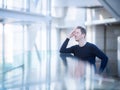 Thoughtful Man Standing At Office