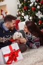 Cheerful young pair with dog at Christmas eve Royalty Free Stock Photo