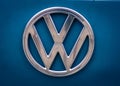 Very clean, old, and shiny Volkswagen logo on a T1 Bulli blue