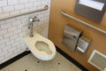 Very clean public ladies room with tiled wall and floor