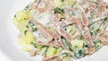 Very close up of the succulent and typical Italian dish Pizzoccheri in a white plate on a table. Typical dish from Valtellina,