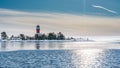 Very close view of red white lighthouse in middle of frozen, snowed island at cold Baltic Sea, partly open water, thin ice Royalty Free Stock Photo