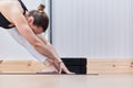 very closed image of a woman stretching on a mat