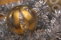 Very closeup view of the silver-golden Christmas decorative glass sphere