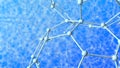 Very complex structure formed by tubes and spheres as molecules with depth of field on blue background