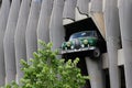 A very crazy parking lot. The facade simulates an accident in which it seems that a car is going to fall into the void.