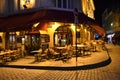 Very cute, colorful and pink cafe facade in Paris Street during night.