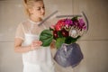 Girl holds giant bouquet with irises and asters Royalty Free Stock Photo